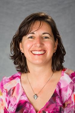 headshot of a woman wearing a multi-red shading blouse